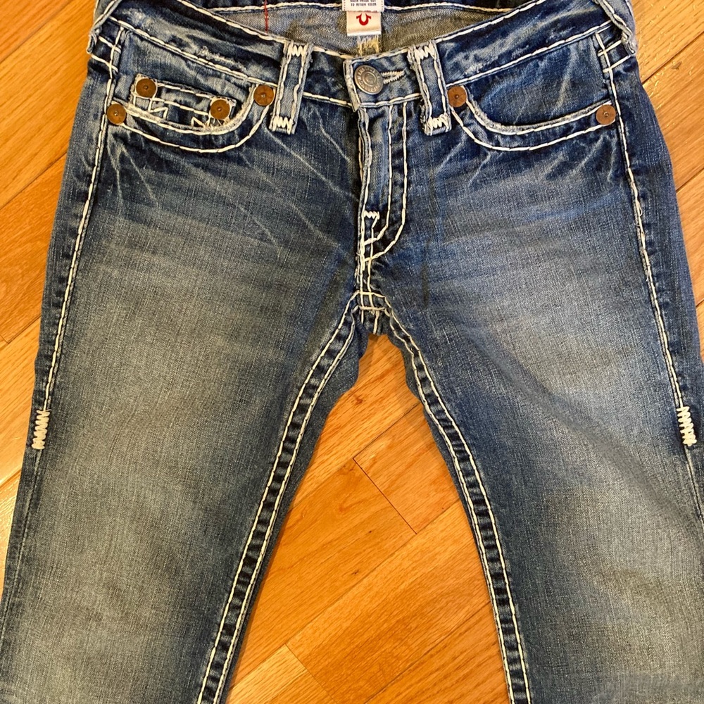 True Religion brand jeans with white stitching details throughout